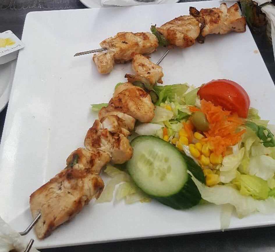 A grilled cut resting on the parrilla